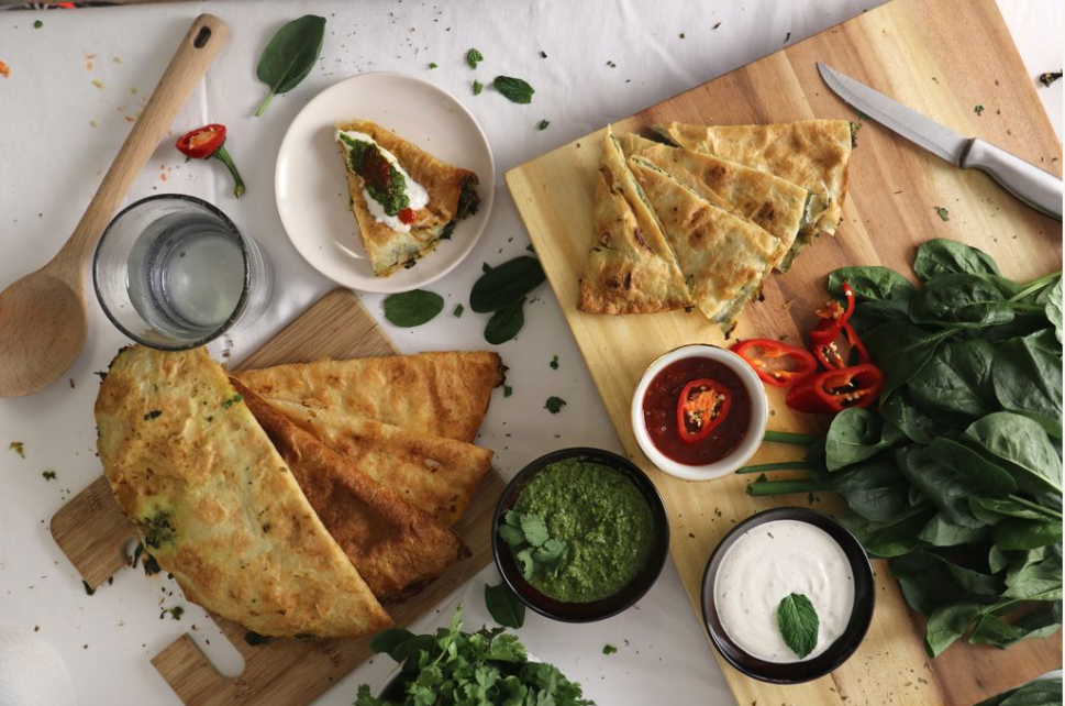 Several pieces of flatbread on a cutting board.